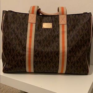 Lg Michael Kors monogram carry on tote.